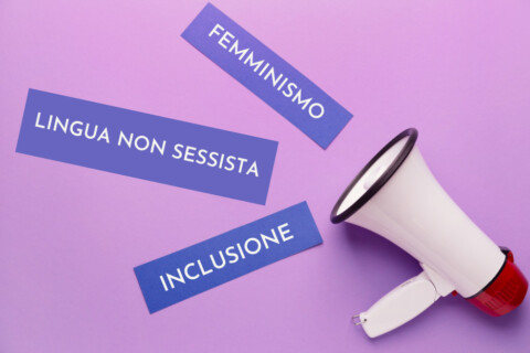 Un megafono dal quale escono le scritte "Femminismo", "Lingua non sessista" e "inclusione"